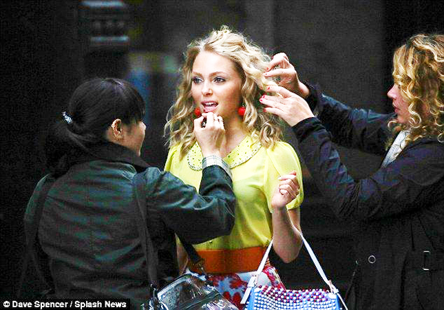Carrie Bradshaw played by Annasophia Robb in 'The Carrie Diaries' gets a hair and make up touch up on set in New York City.  